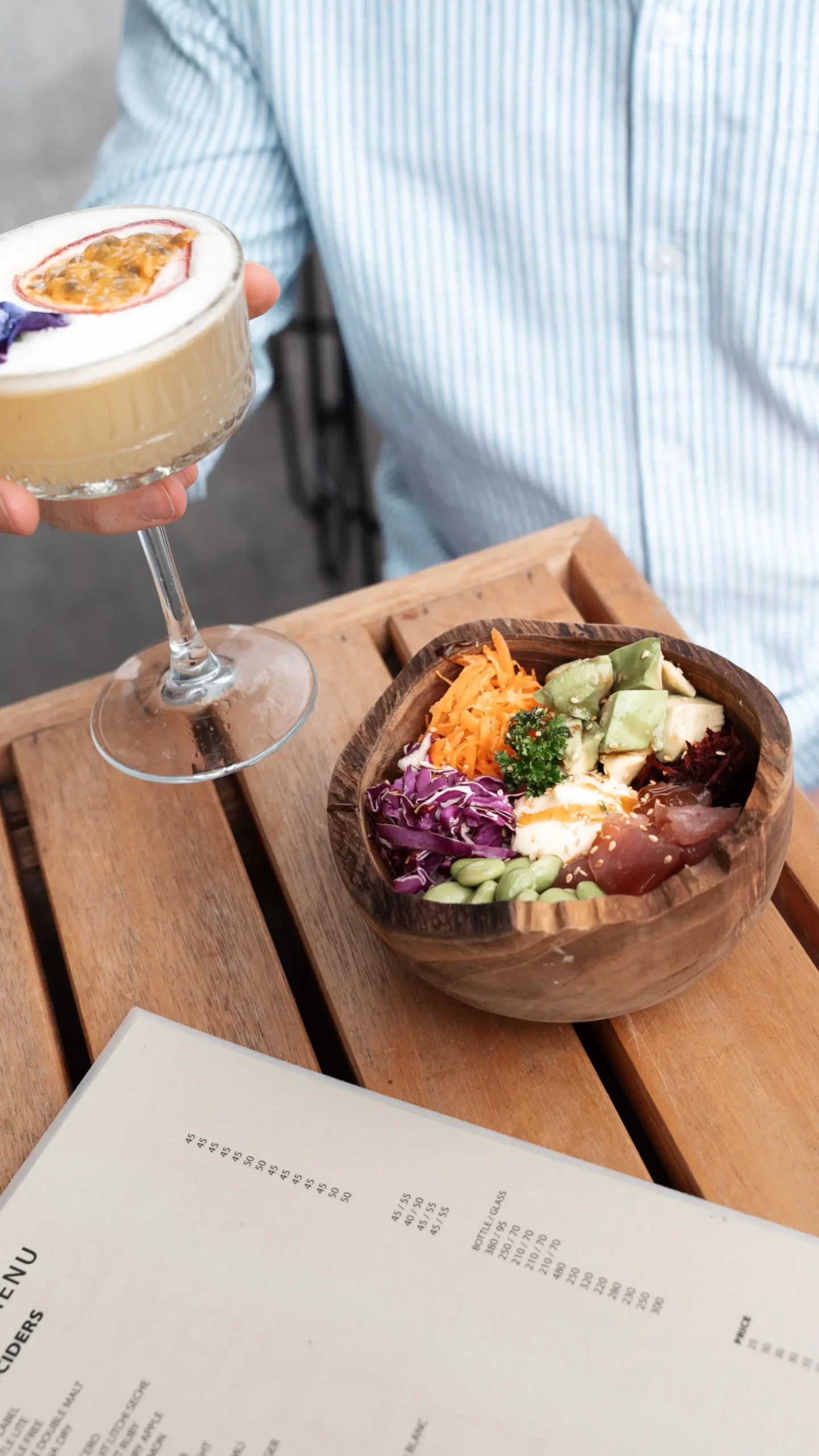 Poke bowl with fresh avocado, tuna, and vegetables served with a tropical cocktail at The Beach Bar Hout Bay.